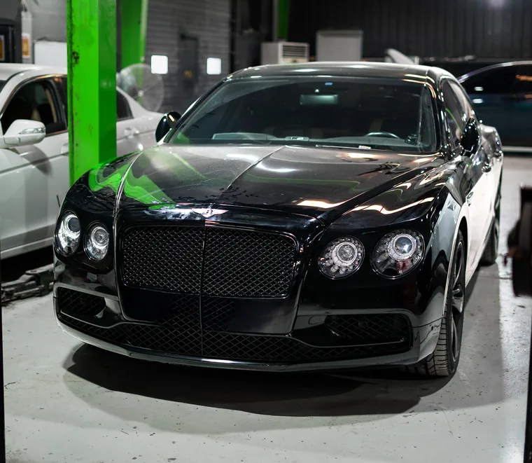 Bentley front end inspection on a lift at the Dubai workshop