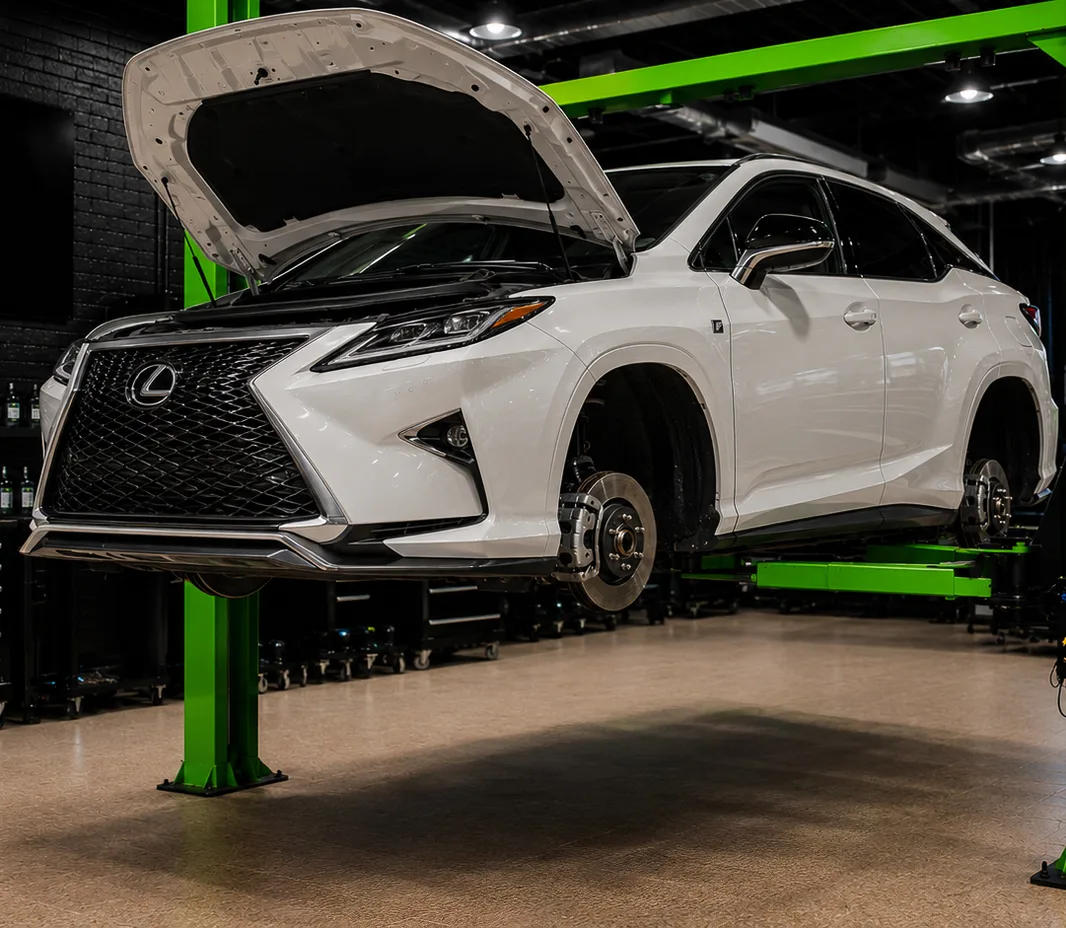 A Lexus raised on a two-post lift in the Dubai workshop