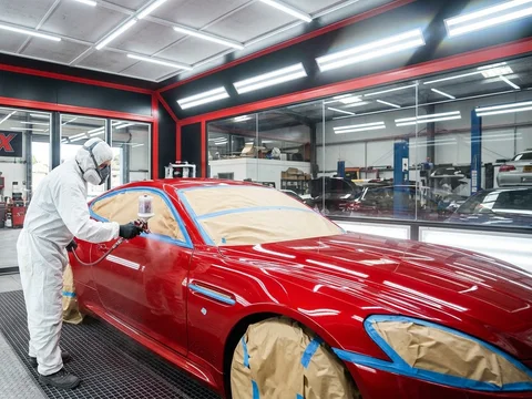 Full car respray in the paint booth at System X Car Polish in Al Quoz, Dubai